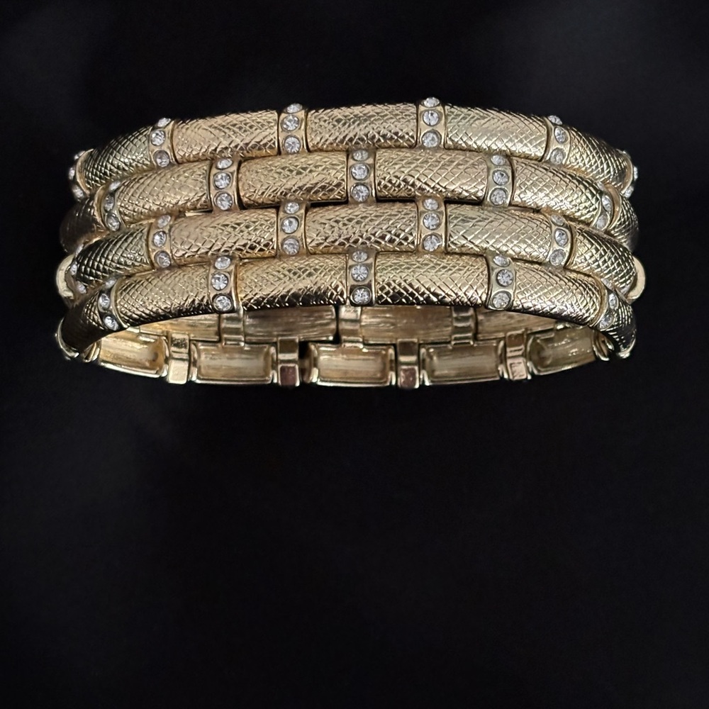 Wide gold-tone textured bangle bracelet with rhinestones